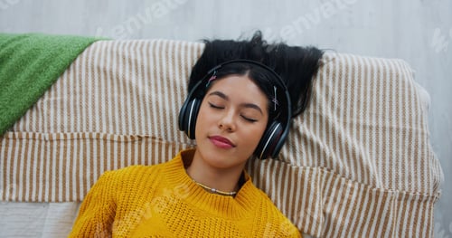 Preview: Home, above and woman with headphones, relax and listening to music, sleeping and sound