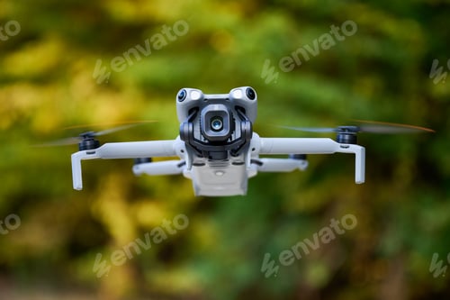 Preview: Drone flying outdoors while capturing stunning aerial views in a natural setting