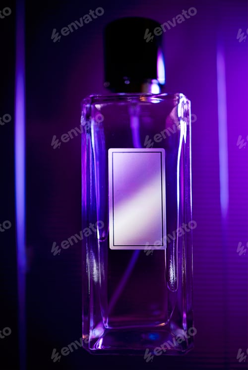 Preview: Transparent perfume bottle with a blank label and black cap illuminated by purple light against a so