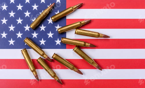 Preview: Assault rifle cartridges on the US flag, serving as a conceptual backdrop for defense