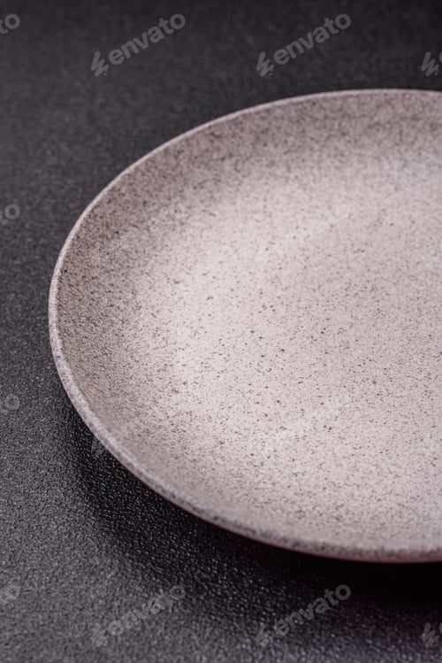 Preview: An empty ceramic round plate, kitchen utensils for a dinner table. An empty plate