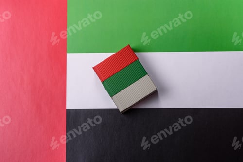 Preview: Cargo containers on the UAE flag as a conceptual backdrop for goods export. Cargo containers