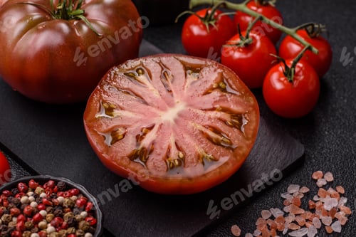 Preview: Fresh pink and black tomatoes adora or kumato as an ingredient for a salad. Tomatoes adora or kumato