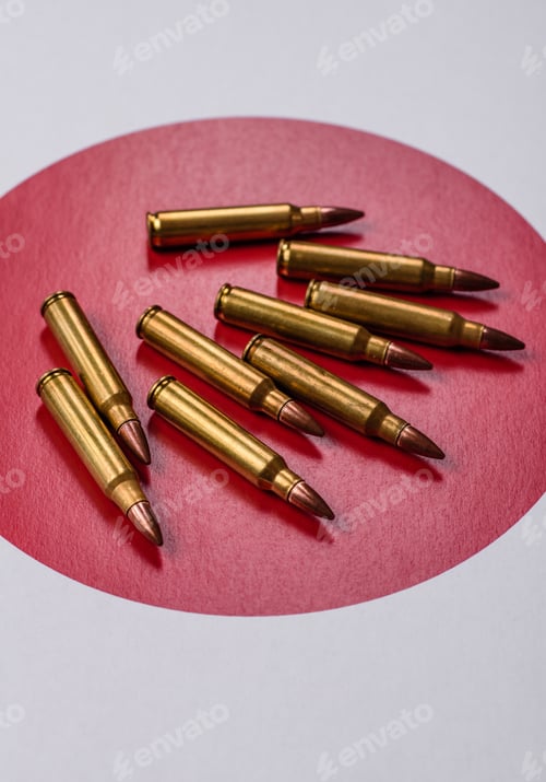 Preview: Assault rifle cartridges on the Japanese flag, serving as a conceptual backdrop for defense