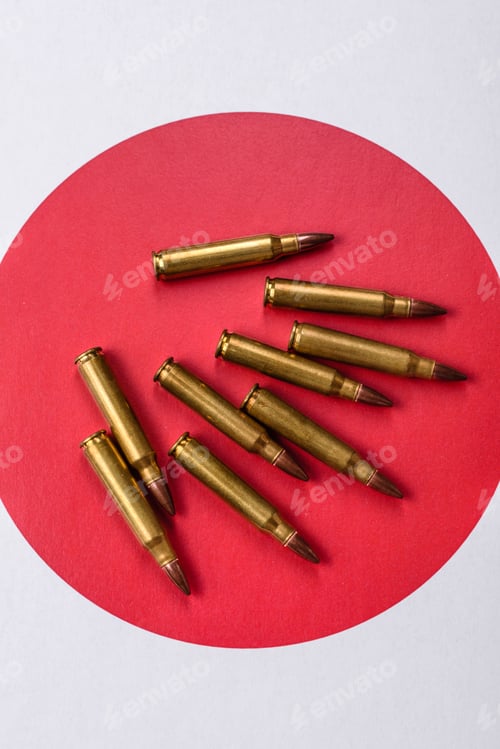 Preview: Assault rifle cartridges on the Japanese flag, serving as a conceptual backdrop for defense