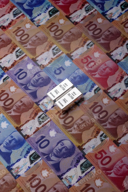 Preview: A silver bar, white metal against a backdrop of Canadian money, as a concept. A silver bar