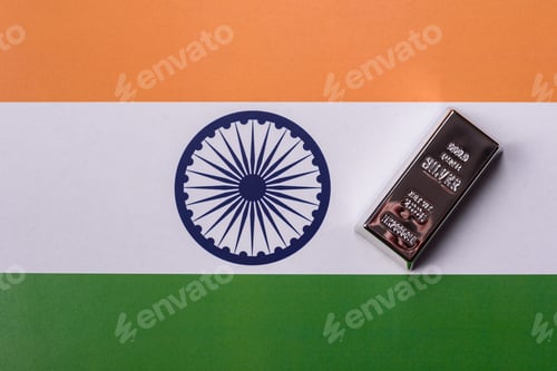 Preview: A silver bar, white metal against a backdrop of Indian flag, as a concept. A silver bar