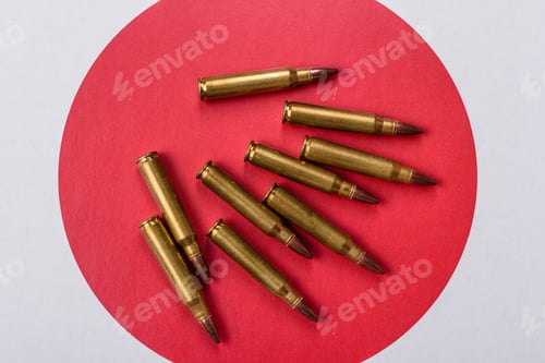 Preview: Assault rifle cartridges on the Japanese flag, serving as a conceptual backdrop for defense