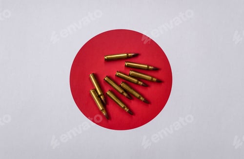 Preview: Assault rifle cartridges on the Japanese flag, serving as a conceptual backdrop for defense