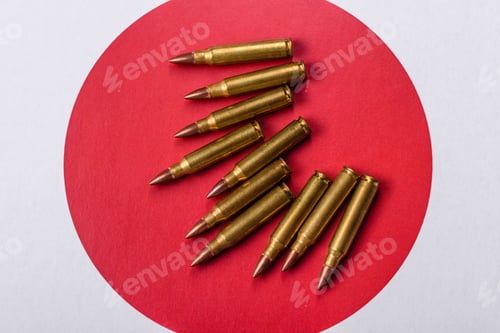Preview: Assault rifle cartridges on the Japanese flag, serving as a conceptual backdrop for defense