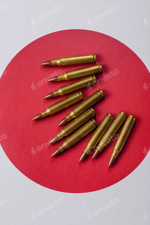 Preview: Assault rifle cartridges on the Japanese flag, serving as a conceptual backdrop for defense