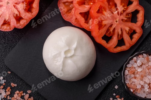 Preview: Fresh white burrata cheese with tomatoes for a salad. Burrata cheese