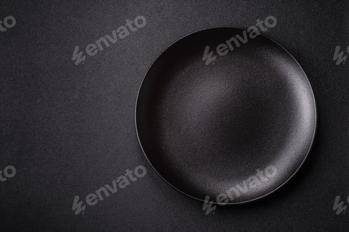 Preview: An empty ceramic round plate, kitchen utensils for a dinner table. An empty plate