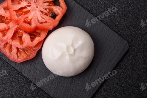 Preview: Fresh white burrata cheese with tomatoes for a salad. Burrata cheese
