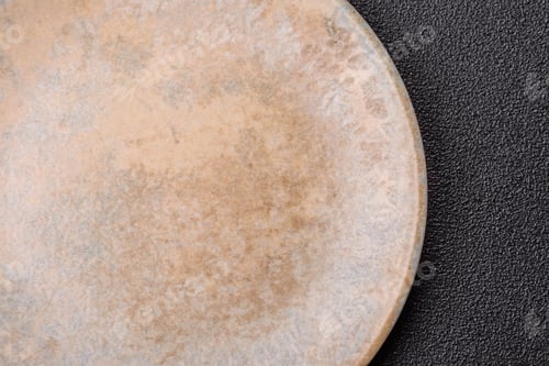 Preview: An empty ceramic round plate, kitchen utensils for a dinner table. An empty plate