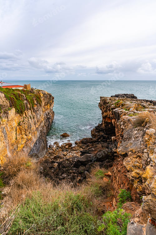 Preview: Rocky coastal cliffs and ocean inlet in Cascais Portugal