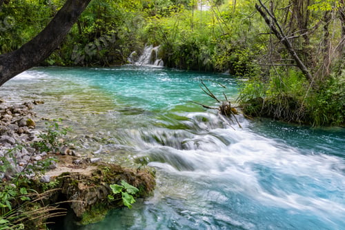 Preview: Scenic Plitvice lakes turquoise river flows dense with small cascades mossy rocks dynamic motion ser