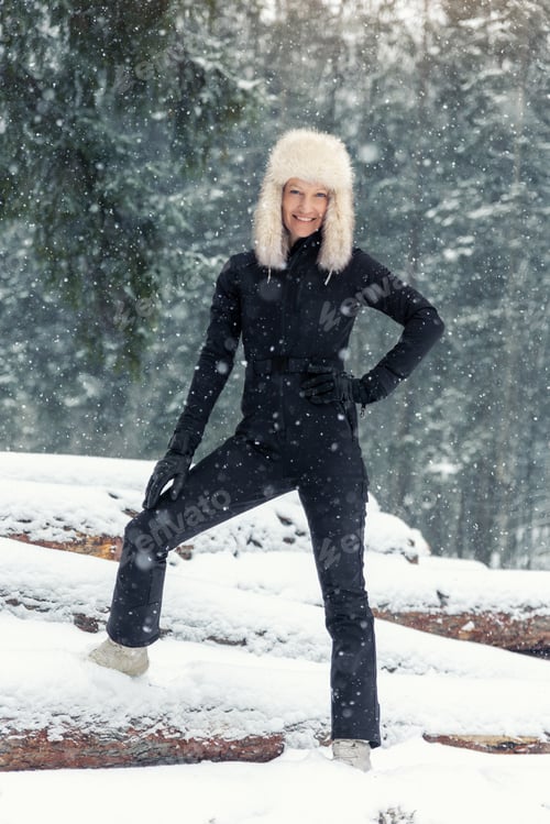 Preview: Portrait young adult mid age smile woman enjoy have fun walking in park forest snowfall cold winter