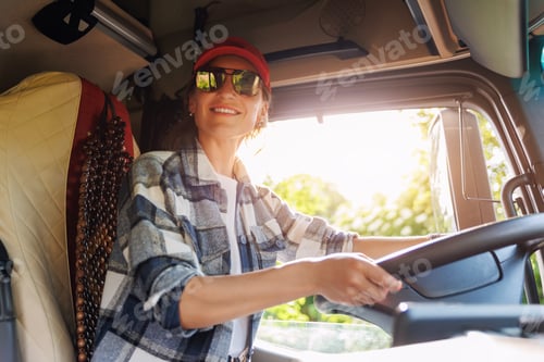 Preview: Portrait young adult happy smiling woman in cabin driving heavy truck driver modern cargo vehicle. F