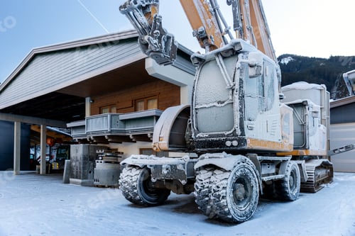 Preview: Scenic view frozen hydraulic excavators standing outdoors winter conditions covered snow ice industr