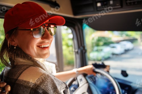 Preview: Portrait young adult happy smiling woman in cabin driving heavy truck driver modern cargo vehicle. F