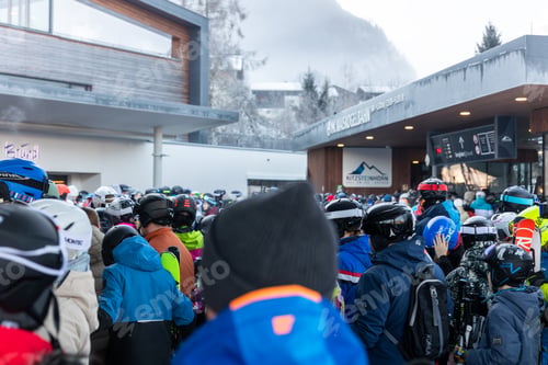 Preview: Kaprun, Austria - December 29, 2025: Back view group people skiers standing queue ski lift gondola s