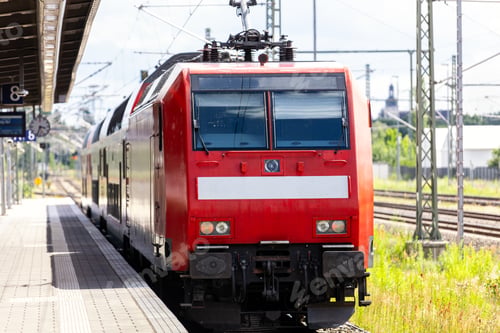 Preview: Red regional train locomotive stand platform german railway station overhead catenary wires tracks.