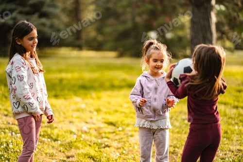 Preview: Group of young girls playing soccer ball outdoors in park