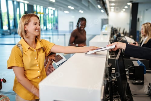 Preview: Woman checking in at airport counter for international travel