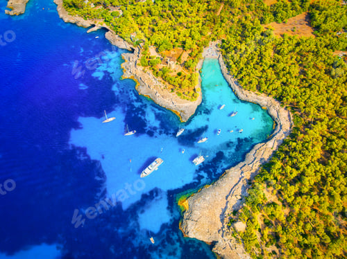 Preview: Aerial view of luxury yachts and boats anchored in a turquoise bay in Mallorca, Spain.