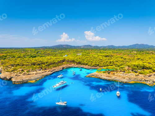 Preview: Aerial view of luxury yachts and boats anchored in a turquoise bay on the coast of Mallorca, Spain.