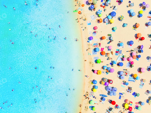 Preview: Top down aerial drone view of a crowded beach with colorful umbrellas and people relaxing.
