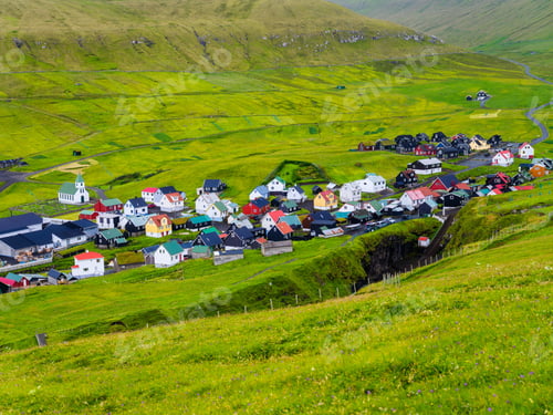 Preview: Scenic Faroe Islands coastal village with colorful houses nestled between green mountains