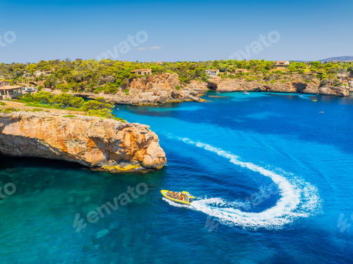 Preview: Aerial view of a boat in a turquoise bay in Mallorca, Spain. Summer vacation concept