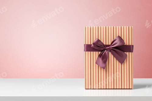 Preview: Gift with purple ribbon placed on white table against pink background