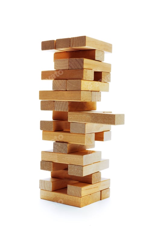 Preview: Wooden blocks stacked high in a game setup on a white background