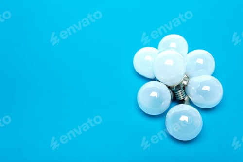 Preview: Light bulbs grouped on blue background for display in a simple arrangement