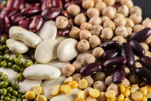Preview: Mix of various beans and legumes displayed together on a dark surface in a close view