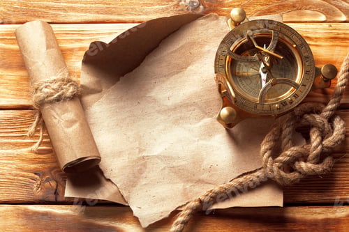 Preview: Old compass and rolled parchment on wooden table showing a travel theme