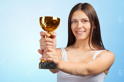 Preview: Winner holds a trophy with a smile in front of a blue background