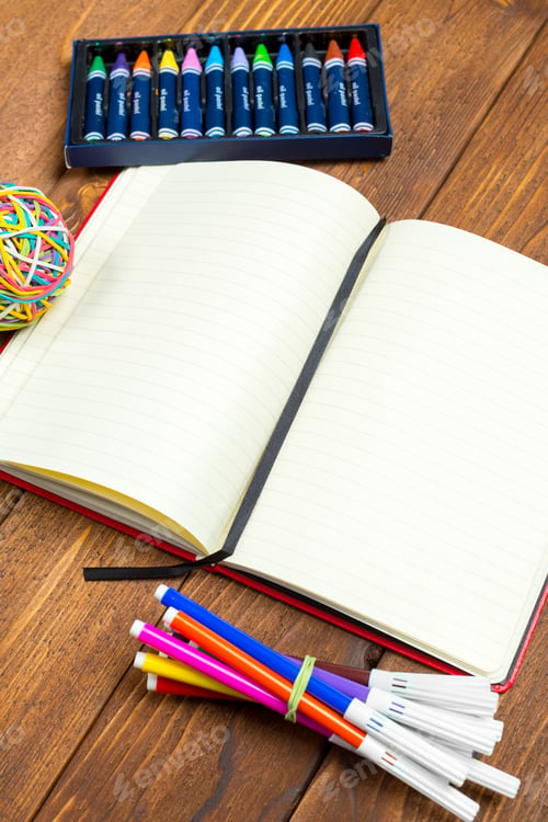 Preview: Kids enjoy drawing and writing with crayons and markers on a blank notebook at home