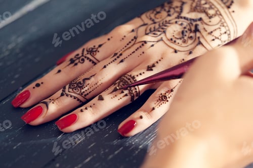 Preview: Henna design on hand during a traditional ceremony in daylight hours