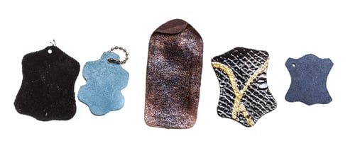 Preview: Different pieces of leather in various shapes and colors arranged in a row for display