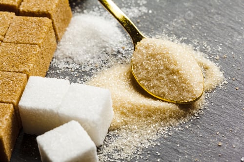 Preview: Different types of sugar arranged on a dark surface with a spoon