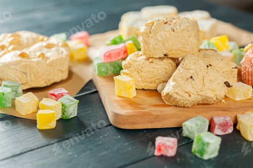 Preview: Treats and sweets on a wooden board with colorful candies in a bright room