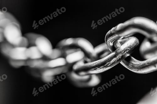 Preview: Chain links close up on dark background showing texture and connections in metal design