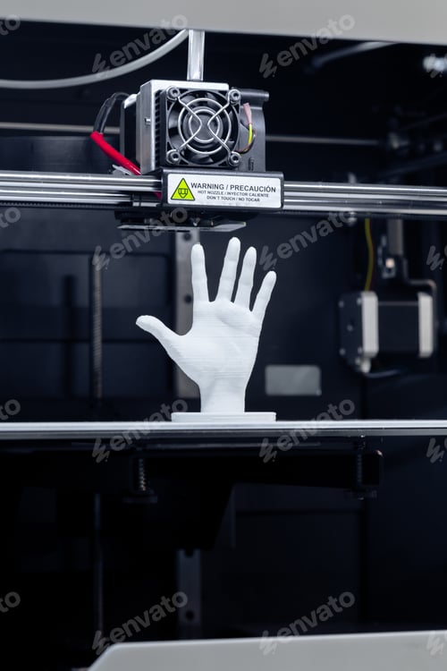 Preview: 3D printer creates a white hand model in a workshop during the day