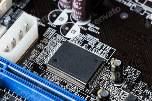 Preview: Circuit board with microchip and electronic components at close range
