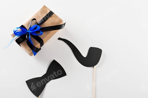 Preview: Gift box with blue ribbon and black props for party