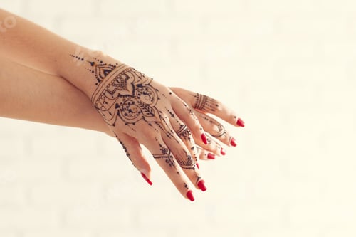 Preview: Hands with henna design and red nails showcase tradition and beauty